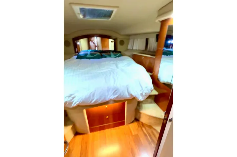 Slide: The Image of Luxurious bedroom interior of 2001 Sea Ray 400 Sedan Bridge yacht. - 8