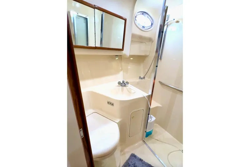 Slide: The Image of Bathroom interior of 2001 Sea Ray 400 Sedan Bridge yacht, featuring shower and vanity. - 9