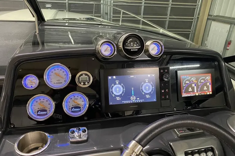 Slide: The Image of Dashboard of a 2020 Formula 350 Sun Sport boat with illuminated gauges and digital displays. - 13