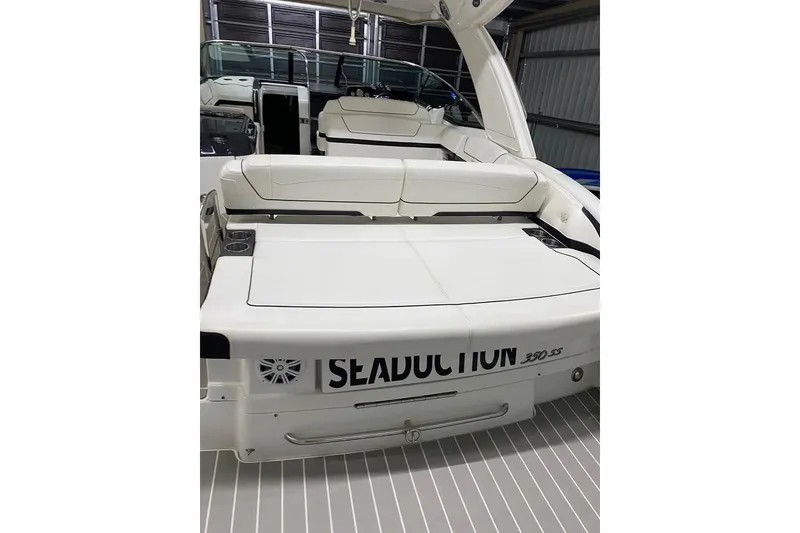 Slide: The Image of 2020 Formula 350 Sun Sport boat with white seating and sleek design in a garage. - 2