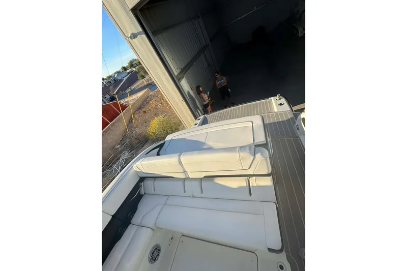 Slide: The Image of 2020 Formula 350 Sun Sport boat in a garage, showcasing sleek design and spacious seating. - 7