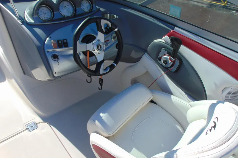 Slide: The Image of Interior of a 2009 Monterey 214FS boat featuring steering wheel and control panel. - 12
