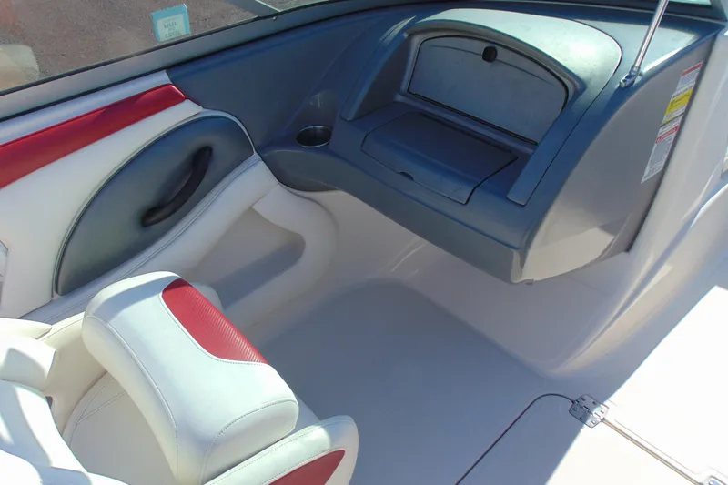 Slide: The Image of Interior of a 2009 Monterey 214FS boat with red and white seating. - 13