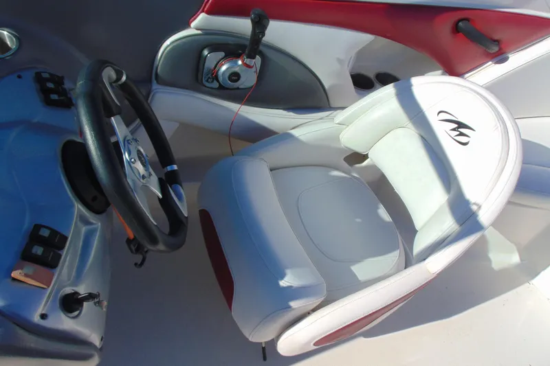 Slide: The Image of 2009 Monterey 214FS boat interior with steering wheel and control panel. - 15