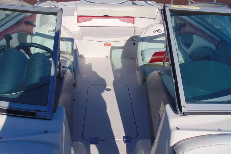 Slide: The Image of 2009 Monterey 214FS boat interior with seating and steering wheel, showcasing spacious design. - 18