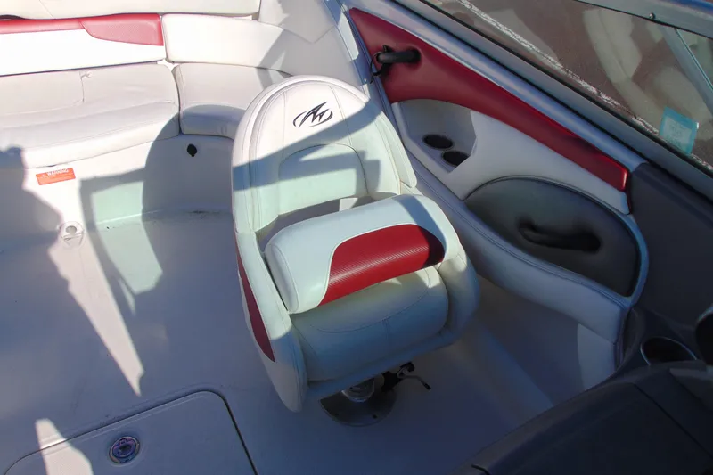 Slide: The Image of Interior of a 2009 Monterey 214FS boat featuring white and red seating. - 19