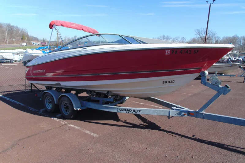 Slide: The Image of Red 2009 Monterey 214FS boat on trailer in parking lot. - 3