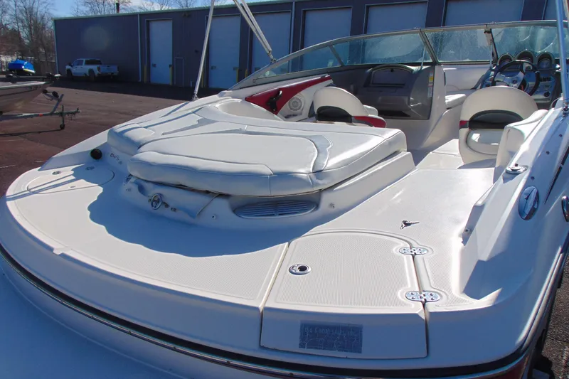Slide: The Image of 2009 Monterey 214FS boat with spacious seating and sleek design in a marina setting. - 6