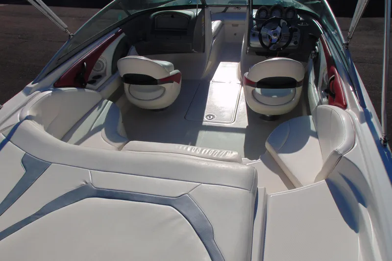 Slide: The Image of 2009 Monterey 214FS boat interior with white seating and modern dashboard. - 7