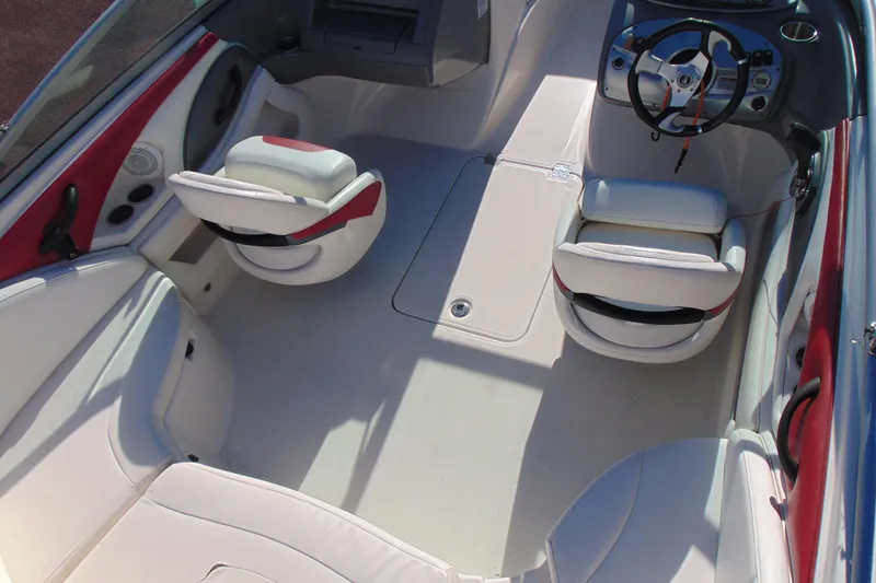 Slide: The Image of Interior of a 2009 Monterey 214FS boat with white and red seating. - 8