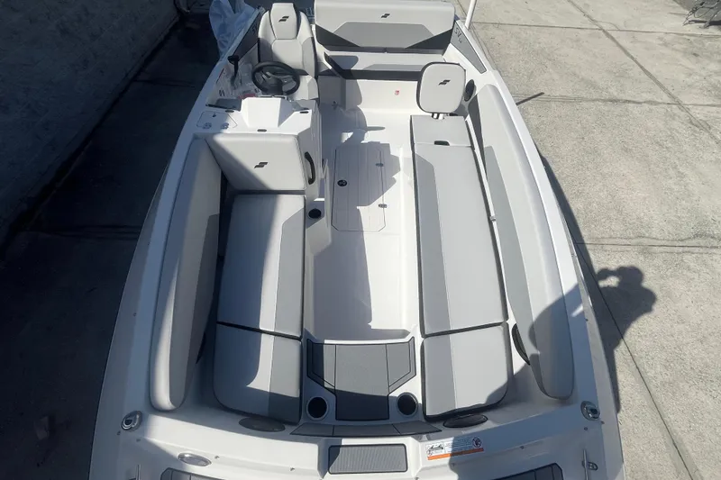 Slide: The Image of 2026 Starcraft SV 18 OB boat interior with gray seating and steering wheel. - 11