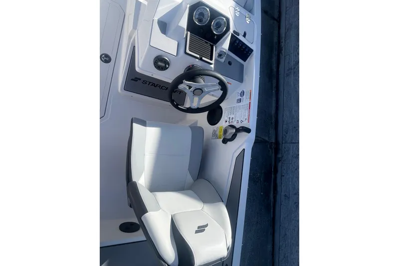 Slide: The Image of 2026 Starcraft SV 18 OB boat cockpit with steering wheel and seat. - 14