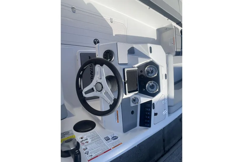 Slide: The Image of Steering console of 2026 Starcraft SV 18 OB boat with gauges and controls. - 15