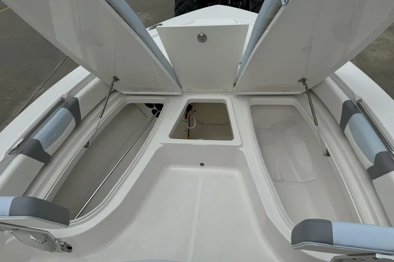 Slide: The Image of 2026 Robalo 206 Cayman boat storage compartments open, showcasing spacious interior design. - 16