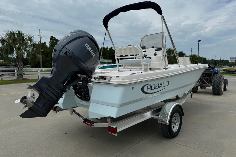 Slide: The Image of 2026 Robalo 206 Cayman boat with Yamaha engine on trailer, parked outdoors. - 3