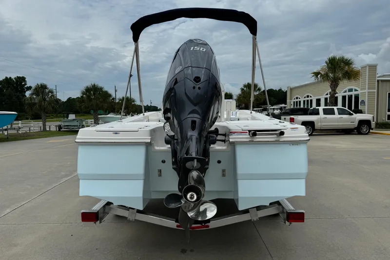 Slide: The Image of 2026 Robalo 206 Cayman boat with outboard motor on trailer, parked outdoors. - 4