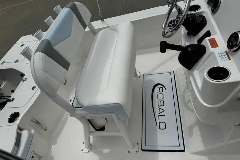 Slide: The Image of 2026 Robalo 206 Cayman boat interior with steering wheel and seating. - 9