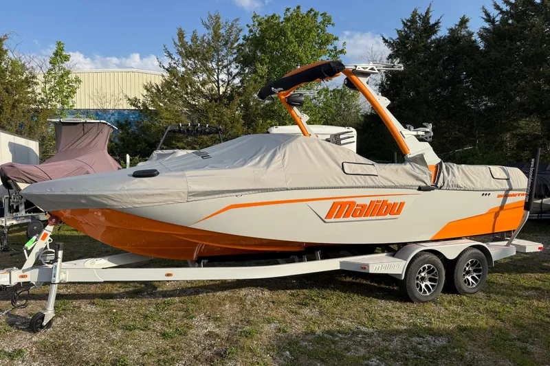 The Image of 2023 Malibu Wakesetter 23 LSV boat on trailer, covered, in outdoor setting. - 0