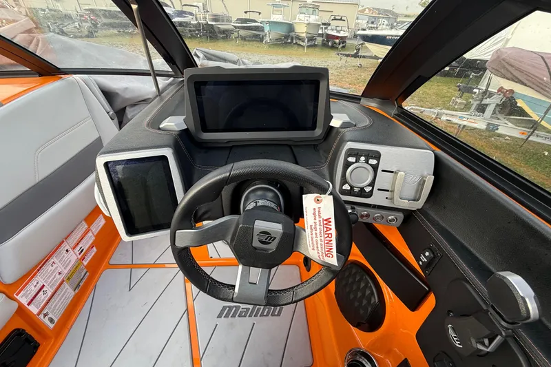 Slide: The Image of 2023 Malibu Wakesetter 23 LSV dashboard with steering wheel and digital displays. - 17