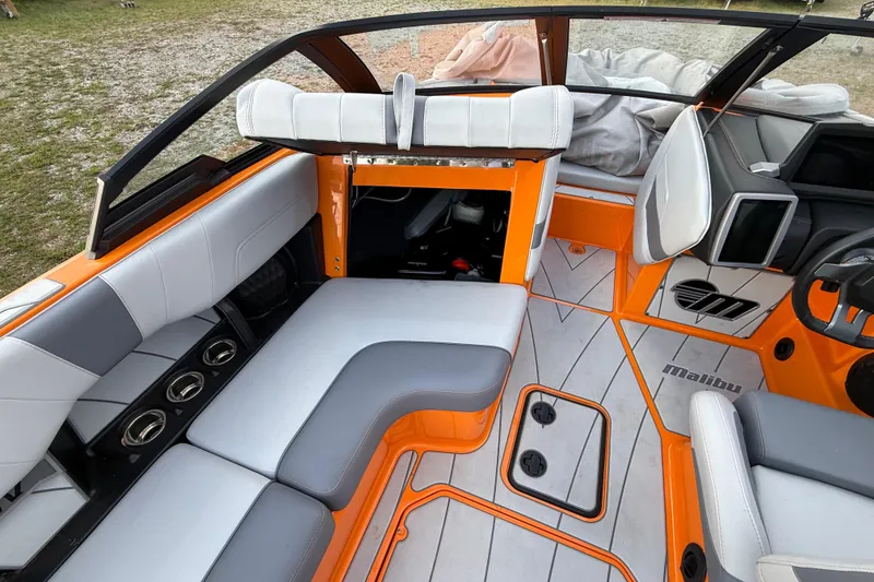 Slide: The Image of 2023 Malibu Wakesetter 23 LSV interior with orange accents and seating. - 18