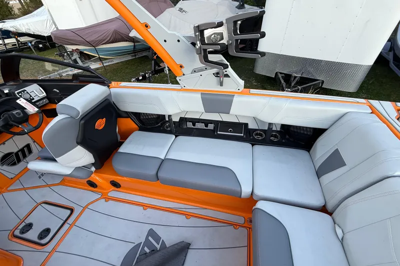 Slide: The Image of 2023 Malibu Wakesetter 23 LSV interior with orange and gray seating, modern design. - 5