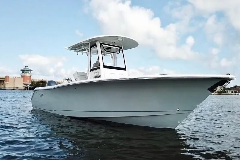 The Image of 2018 Sea Hunt Gamefish 27 Coffin Box boat on calm water under blue sky. - 1