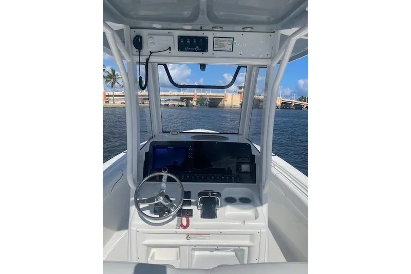 Slide: The Image of 2018 Sea Hunt Gamefish 27 Coffin Box boat helm with steering wheel and controls. - 10