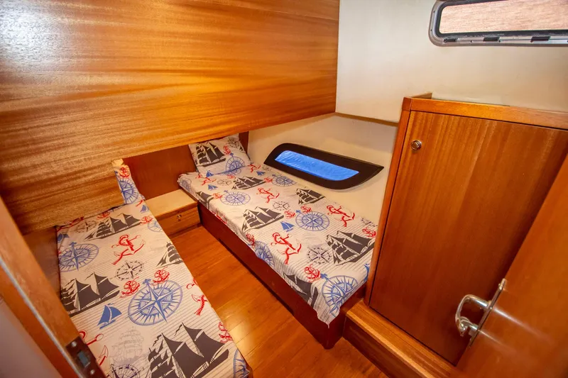 Slide: The Image of Cozy twin cabin in 2019 Monachus 45 Issa yacht with nautical-themed bedding. - 15