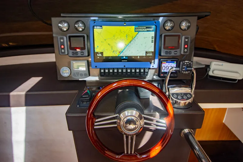 Slide: The Image of Cockpit of 2019 Monachus 45 Issa yacht with navigation controls and wooden steering wheel. - 16