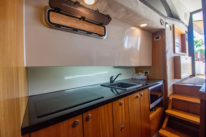 Slide: The Image of Modern kitchen interior of 2019 Monachus 45 Issa yacht with sleek wooden cabinetry. - 19