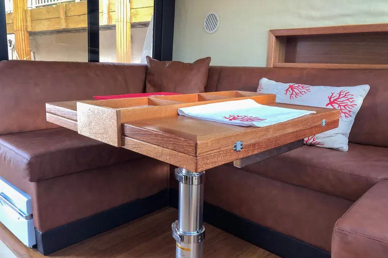 Slide: The Image of Luxurious interior of 2019 Monachus 45 Issa yacht with wooden table and brown seating. - 30