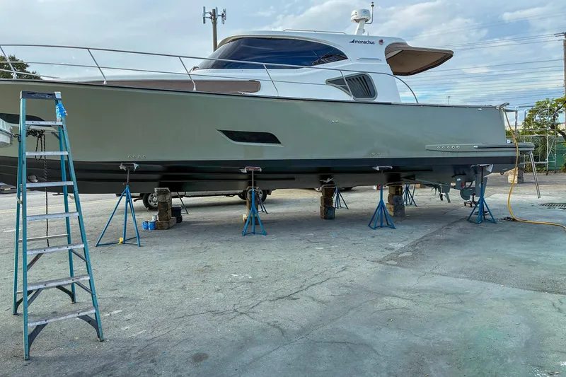 Slide: The Image of Monachus 45 Issa yacht on stands, 2019 model, in a boatyard setting. - 33
