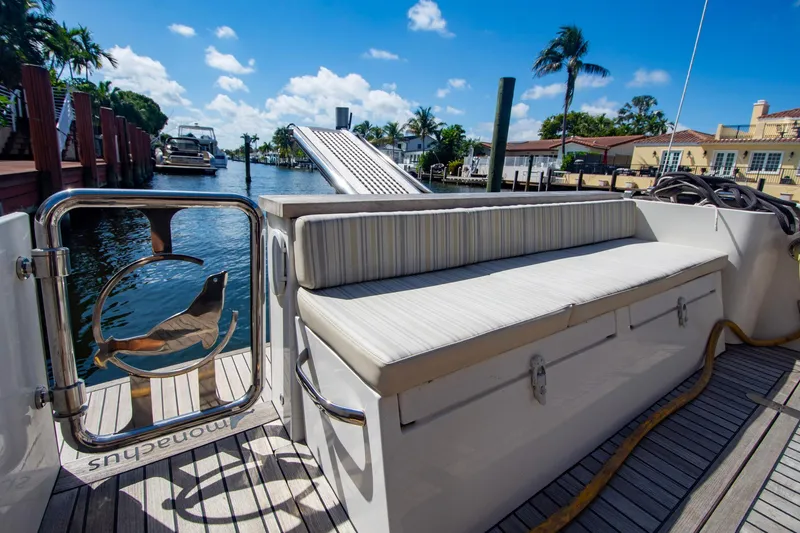 Slide: The Image of Luxury Monachus 45 Issa yacht deck with seating, docked by waterfront homes, 2019 model. - 7