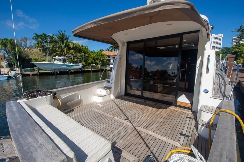 Slide: The Image of Luxury Monachus 45 Issa yacht deck, 2019 model, docked by a scenic waterfront. - 8