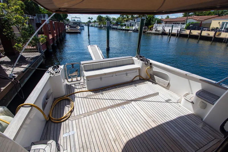 Slide: The Image of Spacious deck of 2019 Monachus 45 Issa yacht docked by a serene waterfront. - 9