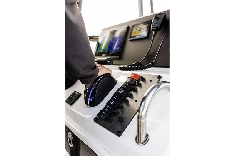 Slide: The Image of Manufacturer Provided Image: Control panel of 2026 Parker 210 Coastal boat with navigation screens and switches. - 5