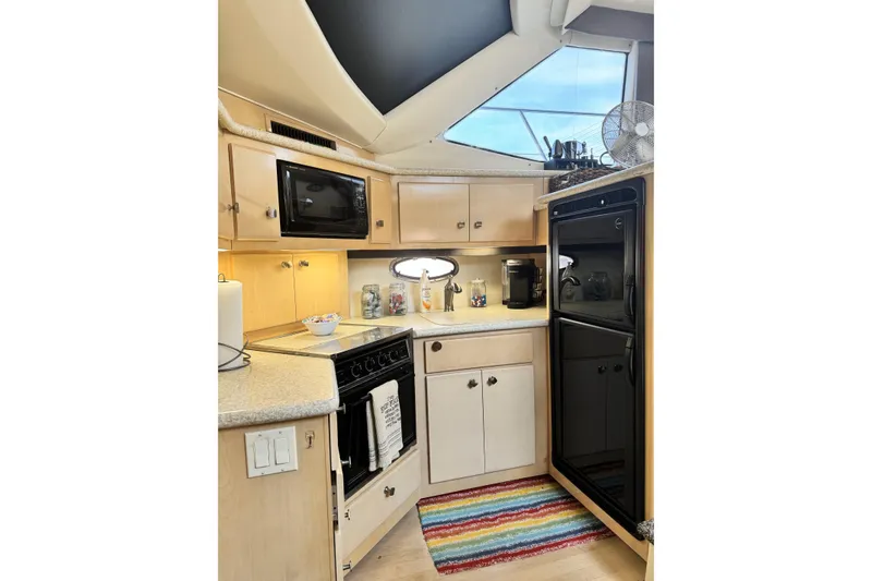 Slide: The Image of Interior kitchen of 2000 Carver 406 Aft Cabin Motor Yacht with modern appliances. - 10