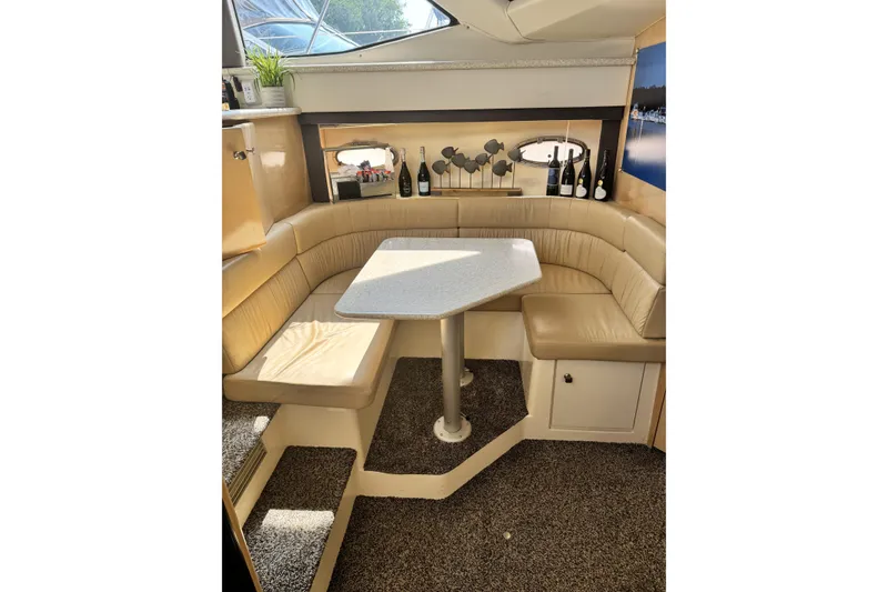 Slide: The Image of Luxurious interior of 2000 Carver 406 Aft Cabin Motor Yacht with cozy seating and table. - 11