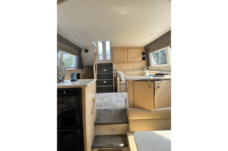 Slide: The Image of Interior of 2000 Carver 406 Aft Cabin Motor Yacht, featuring cozy seating and modern amenities. - 12