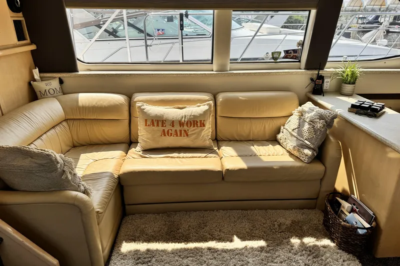 Slide: The Image of Cozy interior of 2000 Carver 406 Aft Cabin Motor Yacht with beige leather seating. - 14
