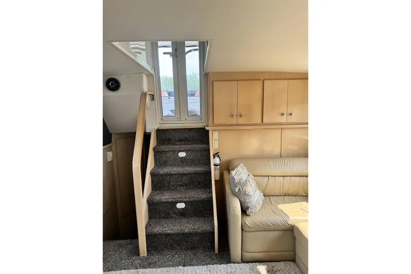 Slide: The Image of Interior of 2000 Carver 406 Aft Cabin Motor Yacht with stairs and seating area. - 15