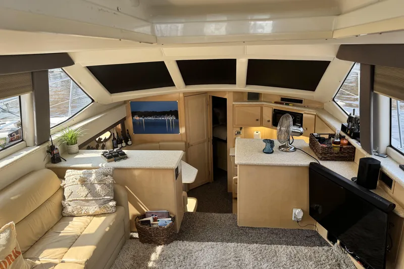 Slide: The Image of Interior of 2000 Carver 406 Aft Cabin Motor Yacht, featuring cozy seating and modern amenities. - 16