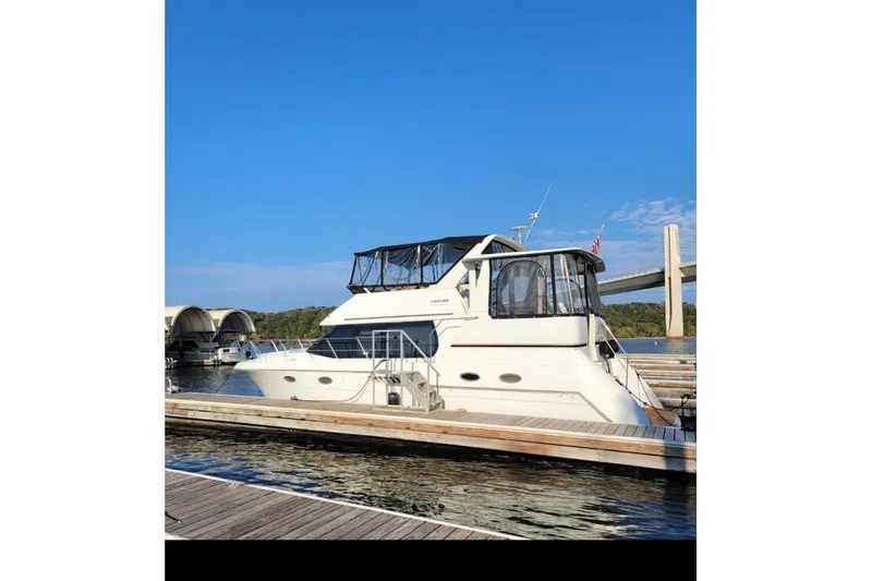 Slide: The Image of 2000 Carver 406 Aft Cabin Motor Yacht docked, blue sky. - 2