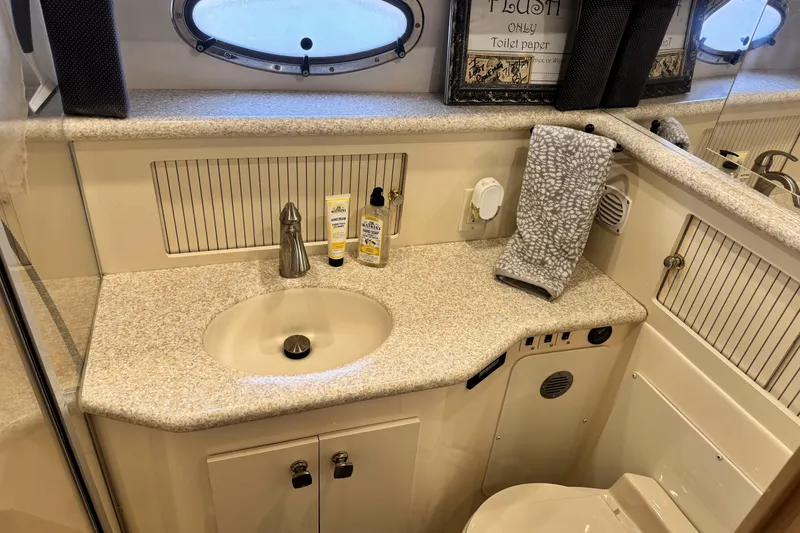 Slide: The Image of Bathroom interior of 2000 Carver 406 Aft Cabin Motor Yacht, featuring sink and toiletries. - 20