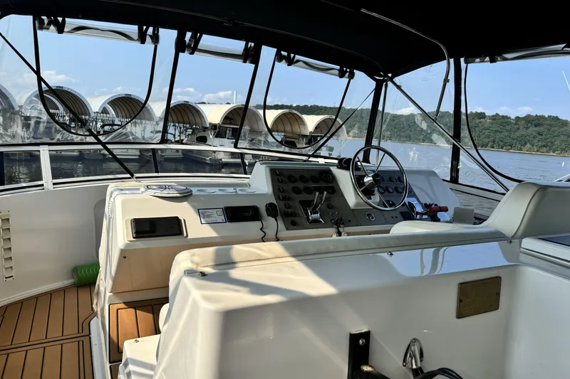 Slide: The Image of 2000 Carver 406 Aft Cabin Motor Yacht helm with scenic marina view. - 27