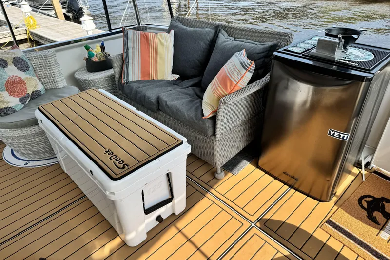 Slide: The Image of Cozy seating area on 2000 Carver 406 Aft Cabin Motor Yacht with fridge and cushions. - 30