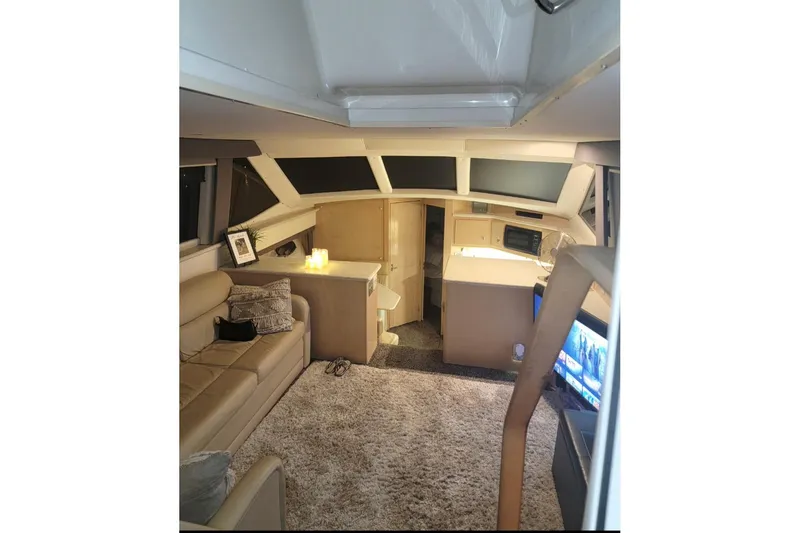 Slide: The Image of Interior of 2000 Carver 406 Aft Cabin Motor Yacht with cozy seating and modern amenities. - 33