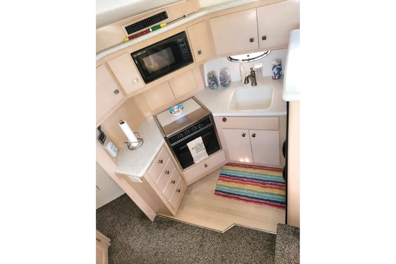 Slide: The Image of Compact kitchen in 2000 Carver 406 Aft Cabin Motor Yacht with modern appliances. - 36