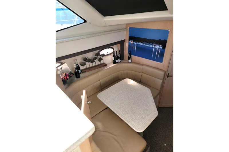 Slide: The Image of Interior of 2000 Carver 406 Aft Cabin Motor Yacht with cozy seating and table. - 37