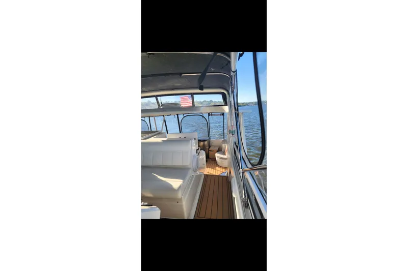 Slide: The Image of 2000 Carver 406 Aft Cabin Motor Yacht interior with seating, on a sunny day. - 38